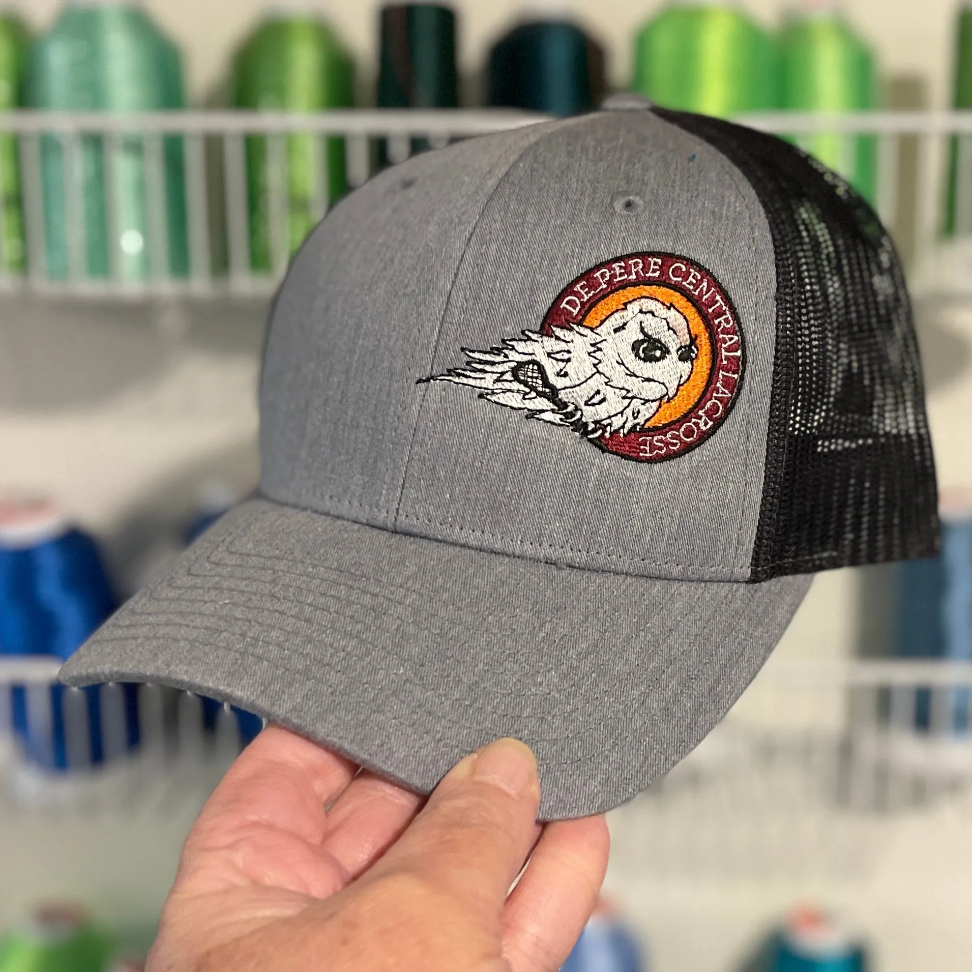 De Pere Central Lacrosse Ghostbirds Trucker Hat in Gray & Black - Logo